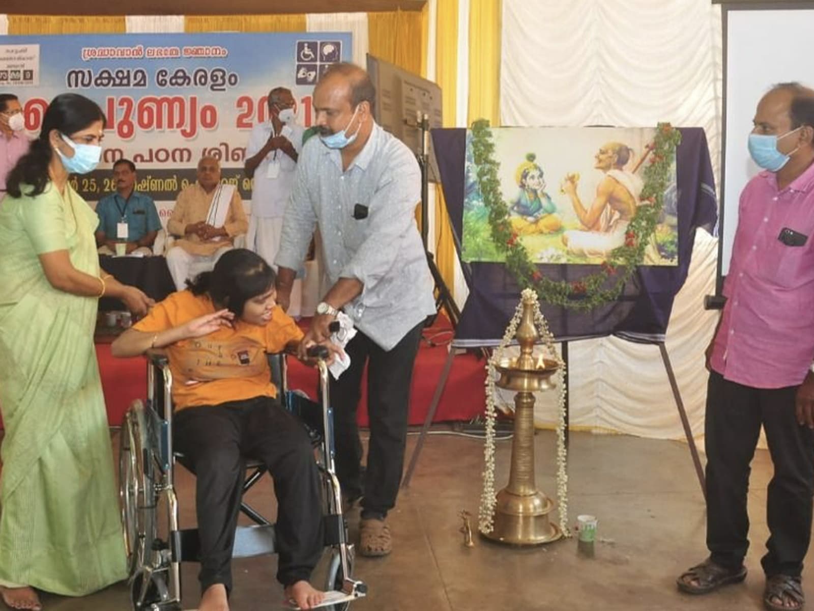Medical staff assisting a participant at a SAKSHAM ADIP health camp